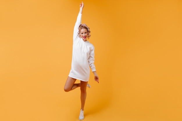 Athletic woman in good mood in sportswear smiling happily