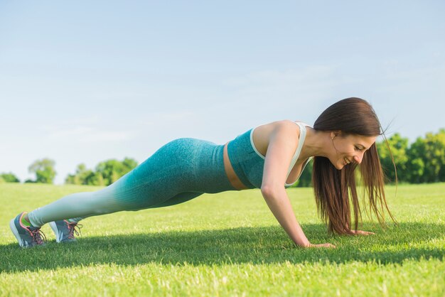 Athletic woman practicing yoga outdoor