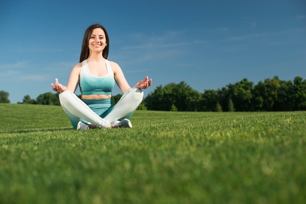 Athletic woman practicing yoga outdoor