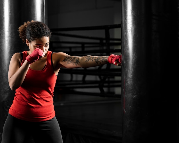 Athletic woman training in boxing center