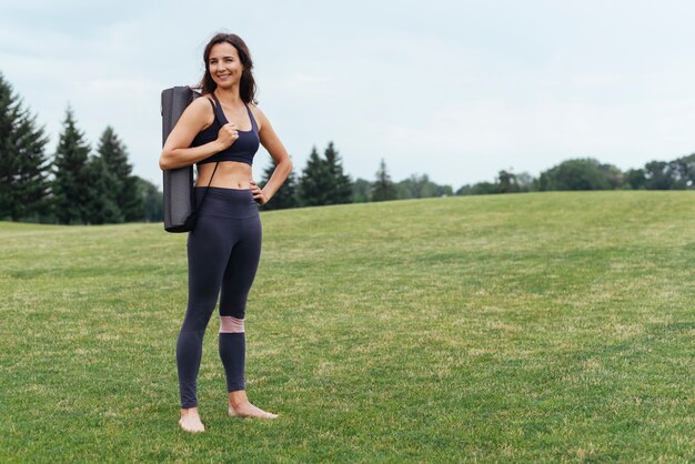 Athletic yoga woman posing outdoors