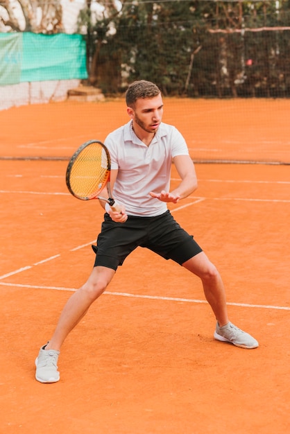 Athletic young boy playing tennis