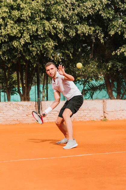 Athletic young boy playing tennis