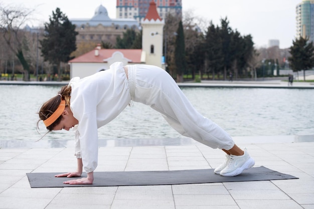 Athletic young girl doing exercises at the park High quality photo