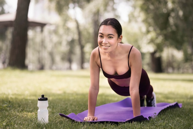 Free photo athletic young woman exercising outdoors