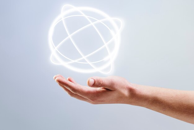 Фон голограммы атома, показывающий на руке человека ремикс науки и техники