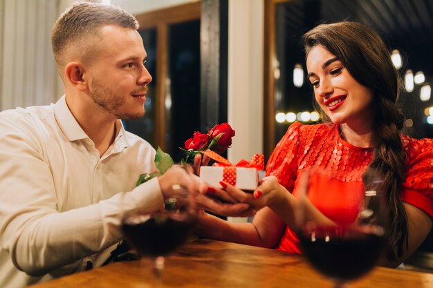 Attentive man giving presents to girl