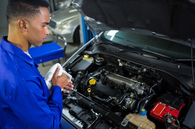 Attentive mechanic servicing car