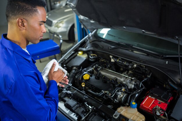 Attentive mechanic servicing car