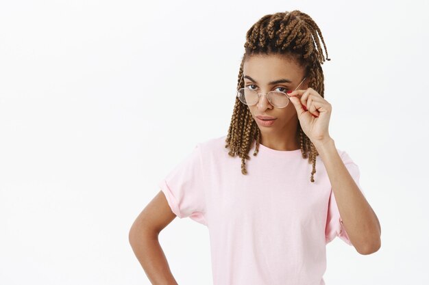 Attractive african-american female student looking suspicious in glasses