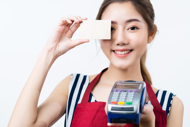 Attractive asian business owner with apron hand present credit card happiness and joyful business owner concept