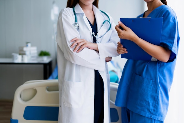 Attractive asian woman nurse and doctor working with smiling and freshness together to takecare ill old senior patient in hospital