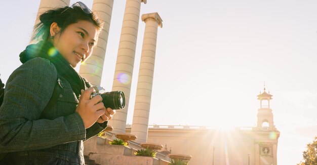 Attractive beautiful asian female casual dress travel backpack take photo with digital camera with smile and joyjul with background of europe building architecture travel concept