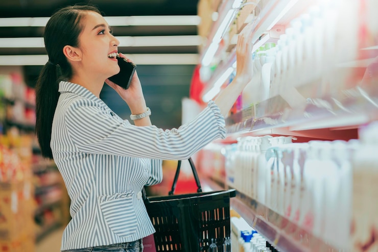 Free Photo attractive beautiful asian young woman shopping for diary products at a grocery storesupermarket shopping in supermarket groceries store standing in aisle with shop trolley buyer choosing product