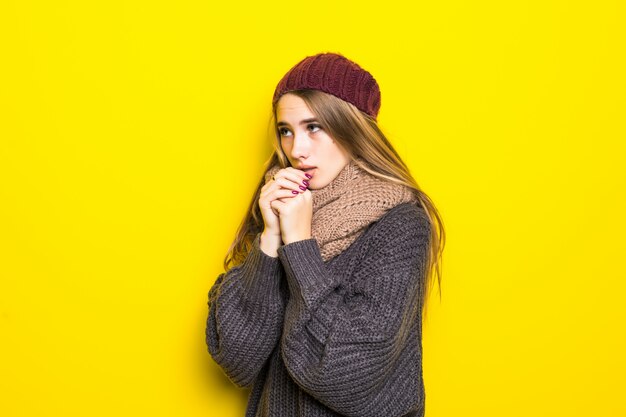 Attractive blonde woman in warm sweater try to warm up