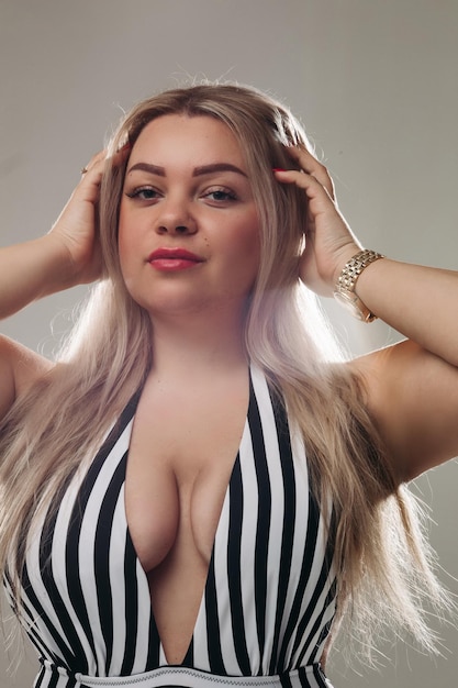 Attractive blonde woman wearing a black and white swimsuit