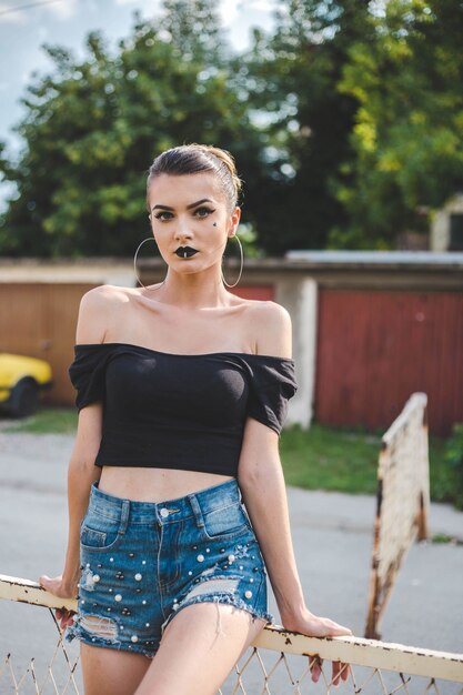 Attractive Bosnian Caucasian woman wearing a black shirt looking at the camera with a serious face