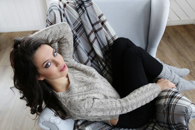 Attractive brunette woman posing in the sofa