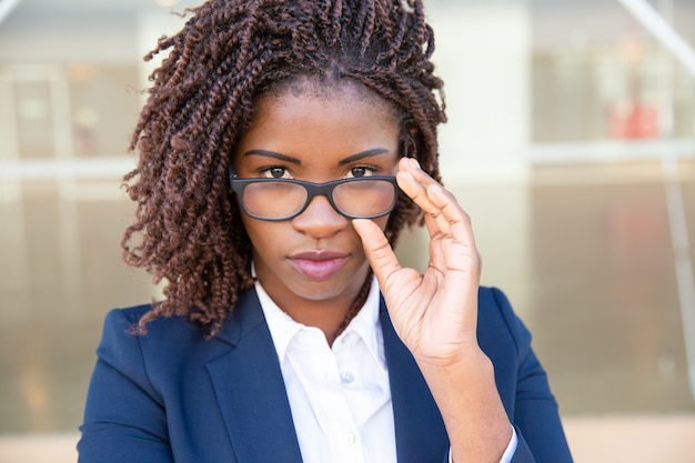 Attractive businesswoman adjusting eyeglasses