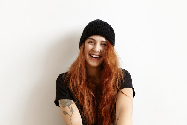 Attractive charming young redhead woman wearing her hair loose smiling joyfully