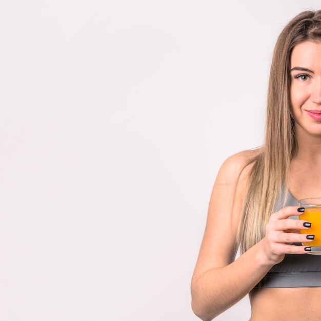 Attractive cheerful woman with glass of juice