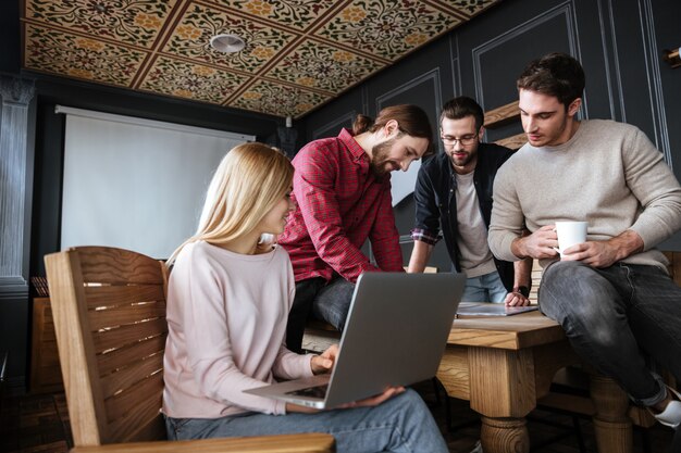 Attractive colleagues standing in office and coworking.