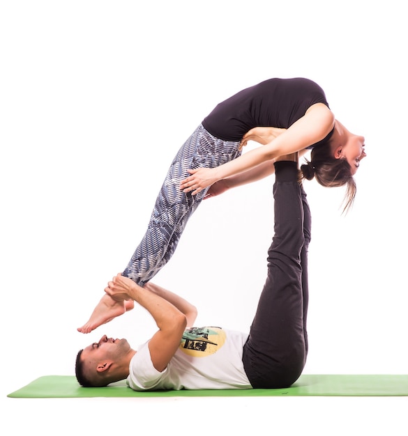 Attractive Couple Doing Yoga Together on white background