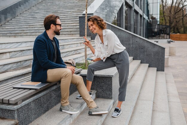 Attractive couple of man and woman talking in urban city center, discussing