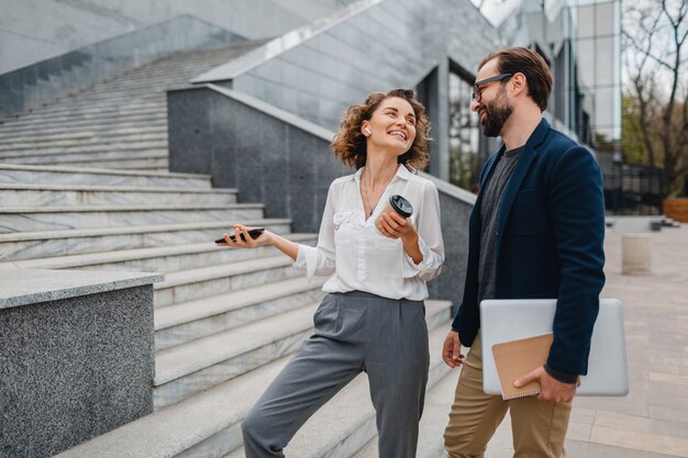 Attractive couple of man and woman talking in urban city center