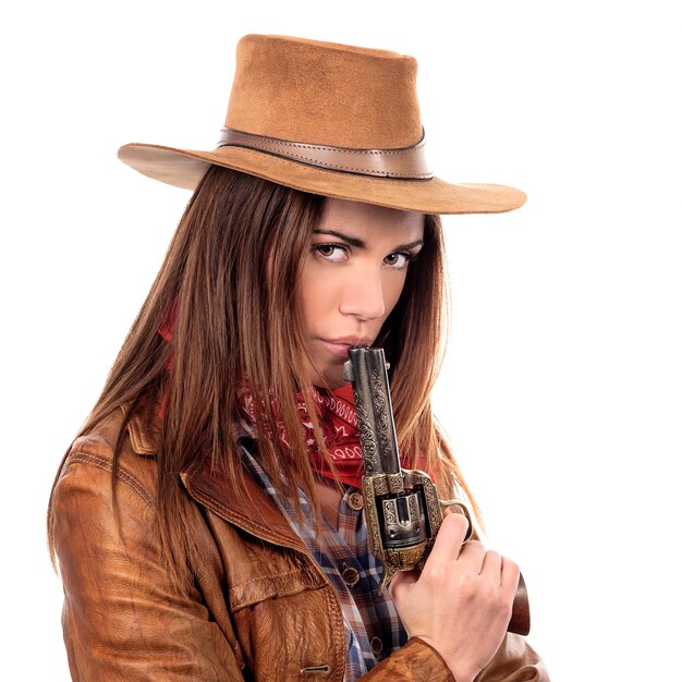 Attractive cowgirl with gun on white background