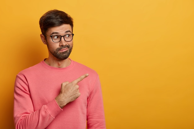 Attractive curious bearded adult man sees something curious and interesting