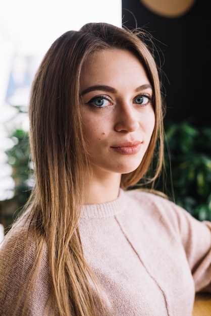 Attractive elegant young woman at bar counter in cafe