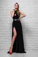 Free photo attractive fashion model posing in black evening dress