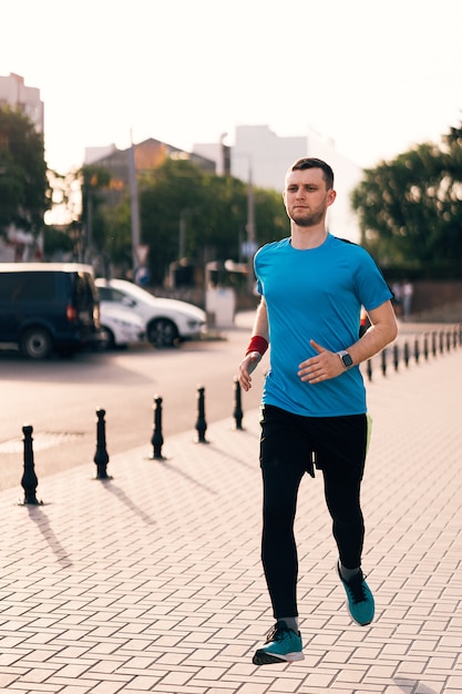 Attractive fit man running in the city