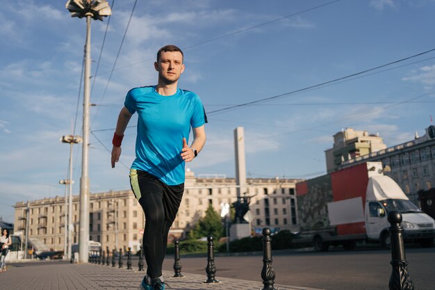 Attractive fit man running in the city