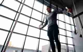 Free photo attractive fit man working out indoors at the gym