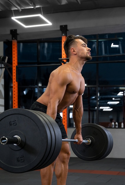 Attractive fit man working out indoors with weights