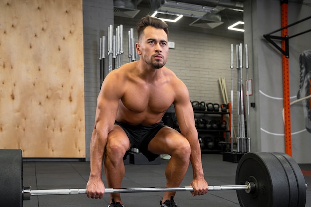Attractive fit man working out indoors with weights
