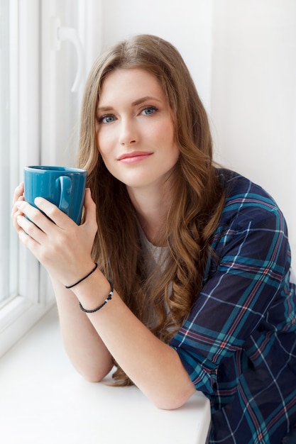 Attractive girl by the window