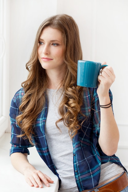 Attractive girl by the window