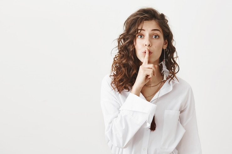 Free Photo attractive girl hiding secret, hush as asking be quiet
