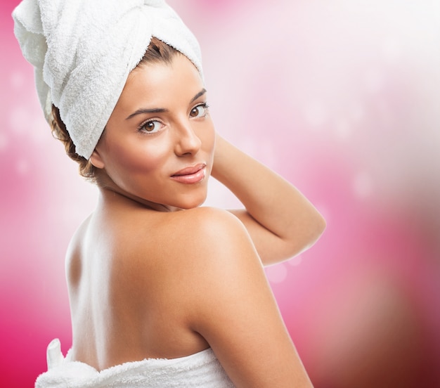 Free photo attractive girl in white towel over pink background.