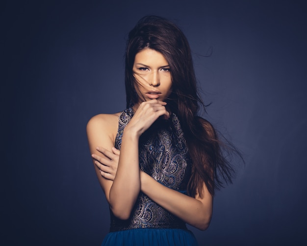 Attractive girl with flying hair posing in studio