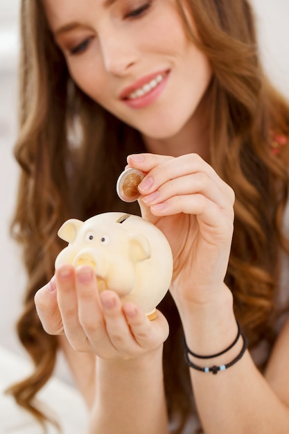 Free photo attractive girl with moneybox