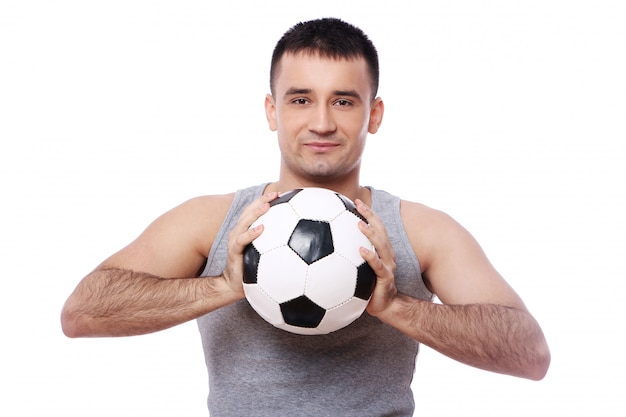 Attractive guy holding soccer ball