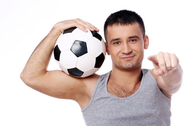 Attractive guy holding soccer ball