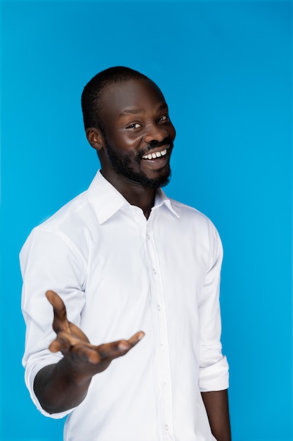 Attractive handsome man smiles and gives his hand