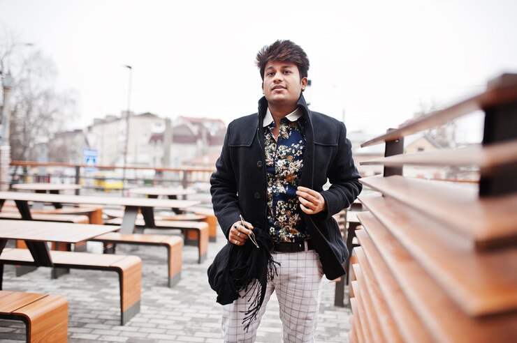 Free Photo attractive and handsome stylish indian man wear on black coat standing in the terrace of modern lounge cafe at his work break