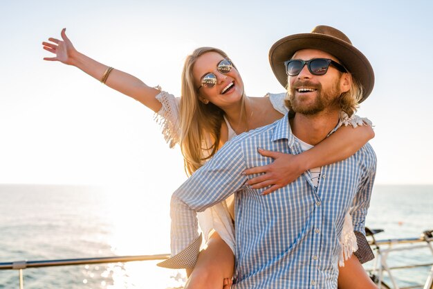 Attractive happy couple laughing traveling in summer by sea