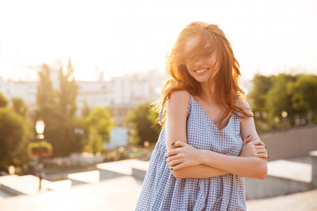 Attractive happy woman standing with arms folded